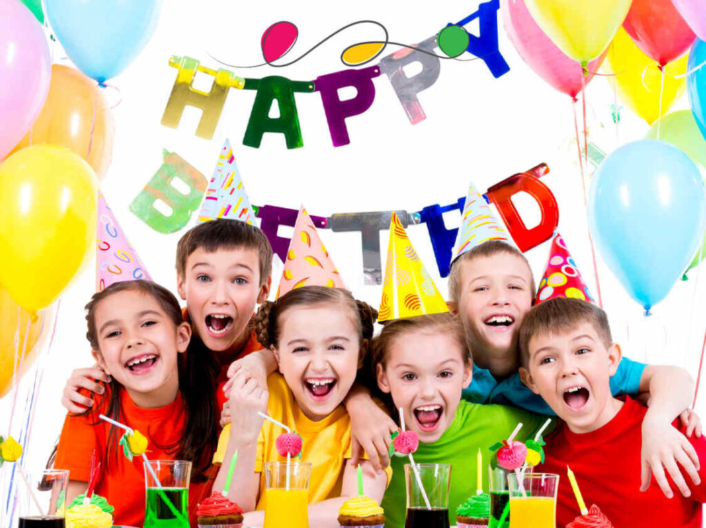 Excited children at a magical birthday party planned by Kids Day Events, featuring a face painter and a singing princess in Abu Dhabi.