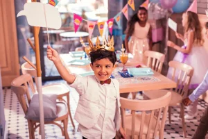Child celebrating birthday at a themed kids party